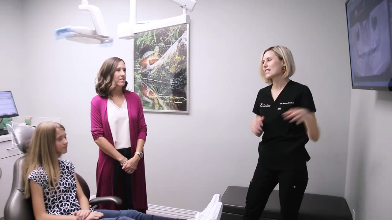 A teenage patient and her mother meeting the surgeon in the operatory before treatment