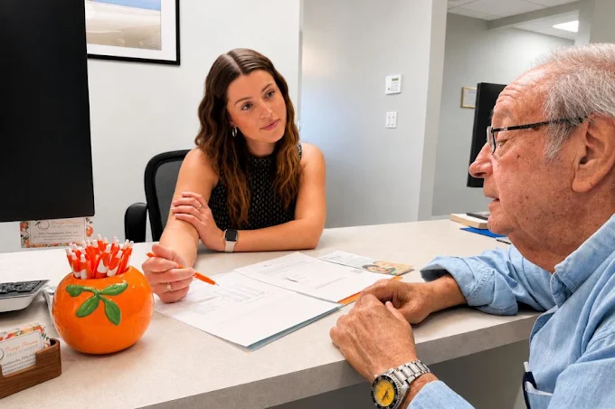 A patient talking through a treatment plan with a coordinator at the front desk