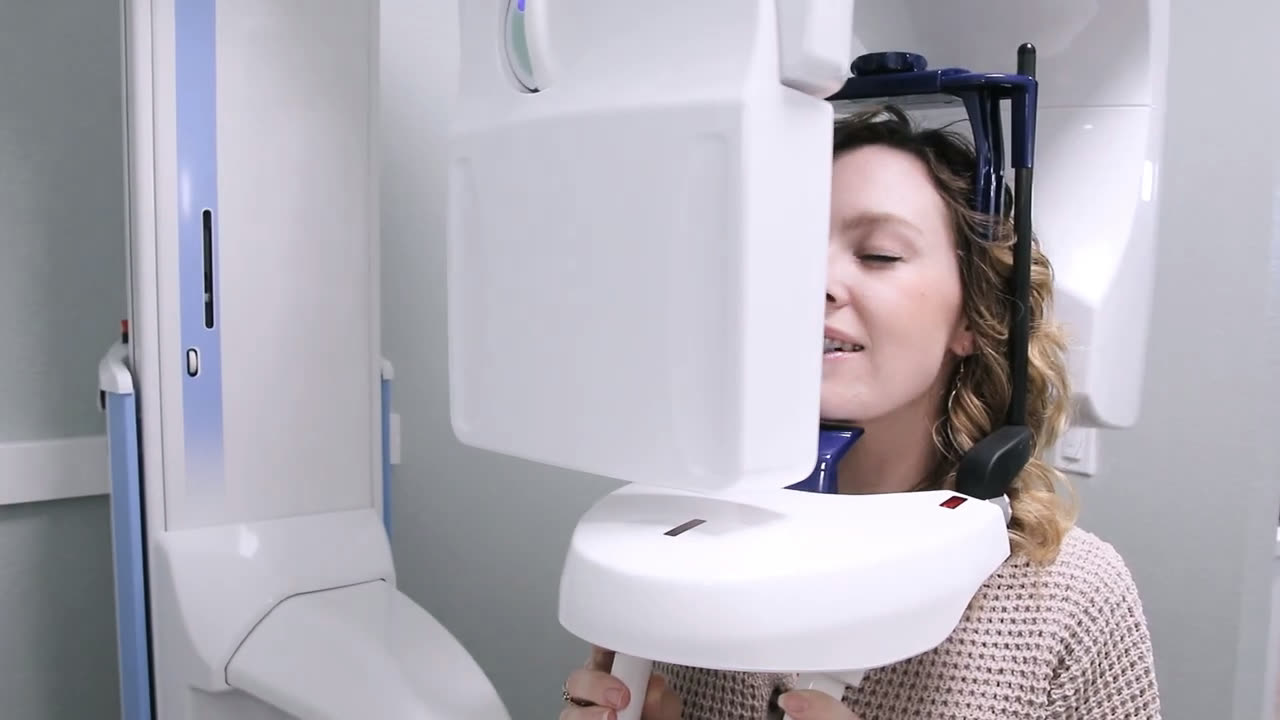 A patient having a 3D scan taken on the imaging machine in the office